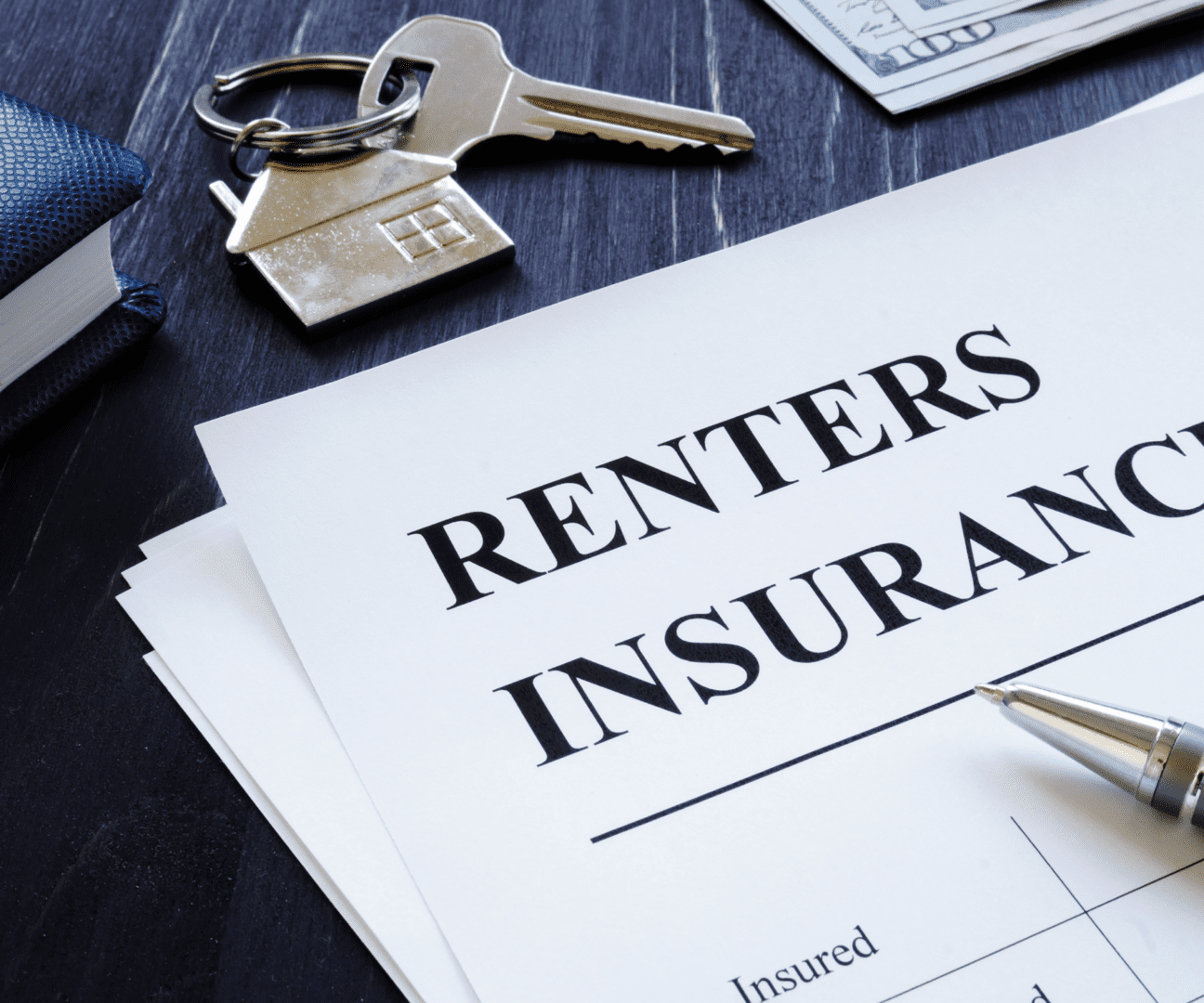 Documents titled 'Renters Insurance' with keys and a pen on a table.