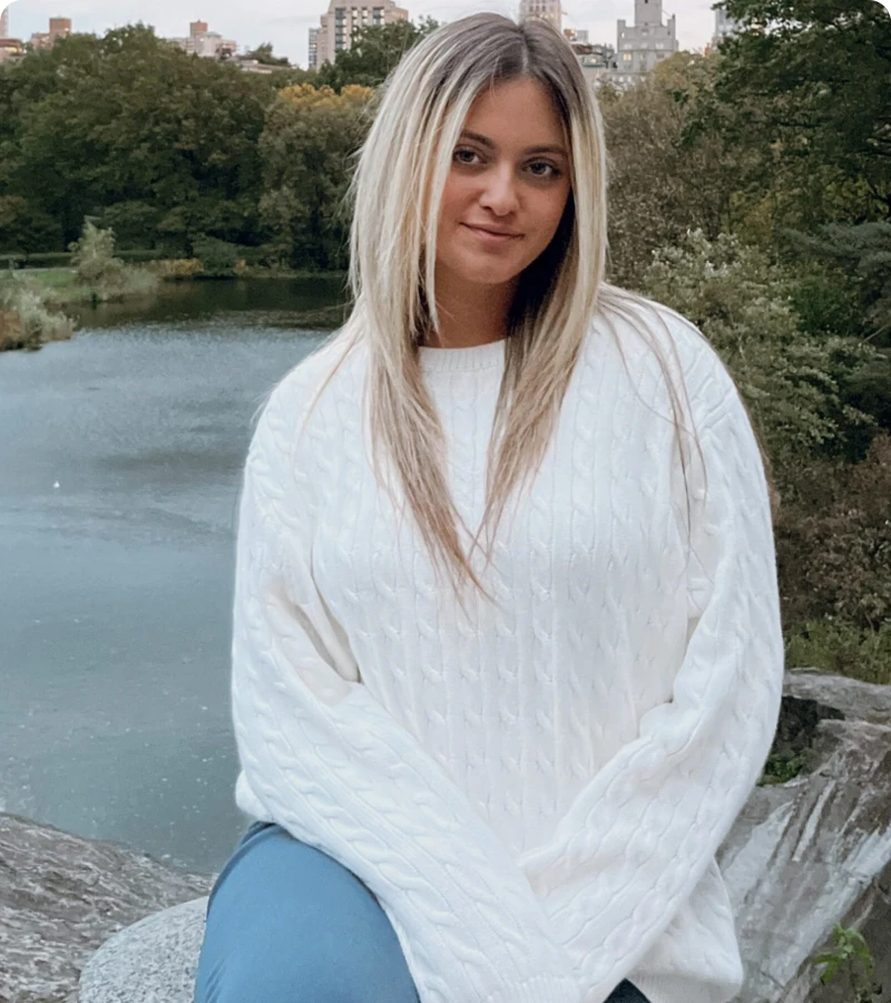 Blonde woman sitting near water