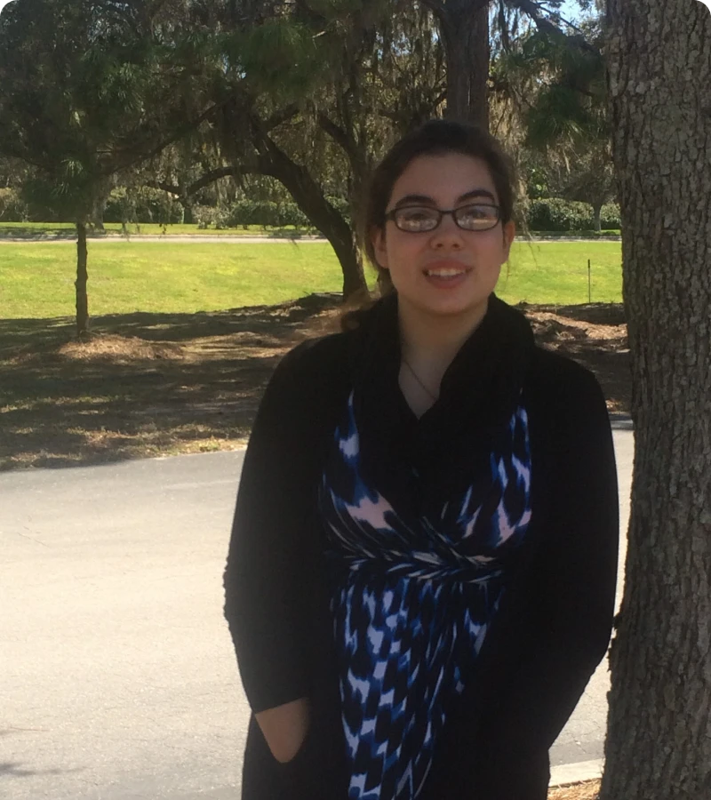 Woman in patterned dress near trees