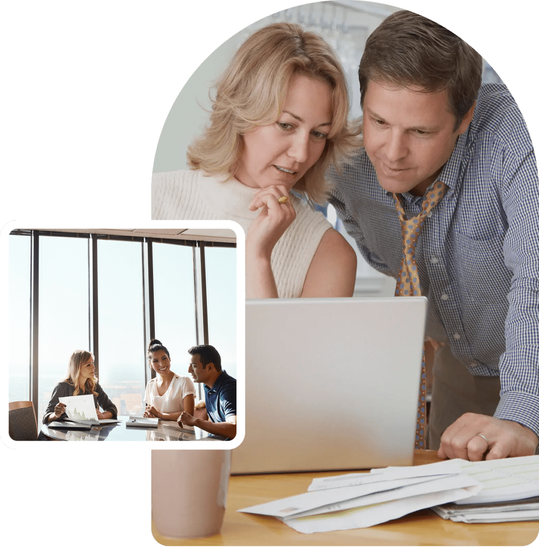 Two professionals collaborating at a laptop in an office environment.