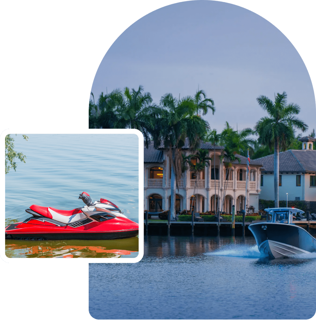A jet ski on calm water with a large house and palm trees in the background.