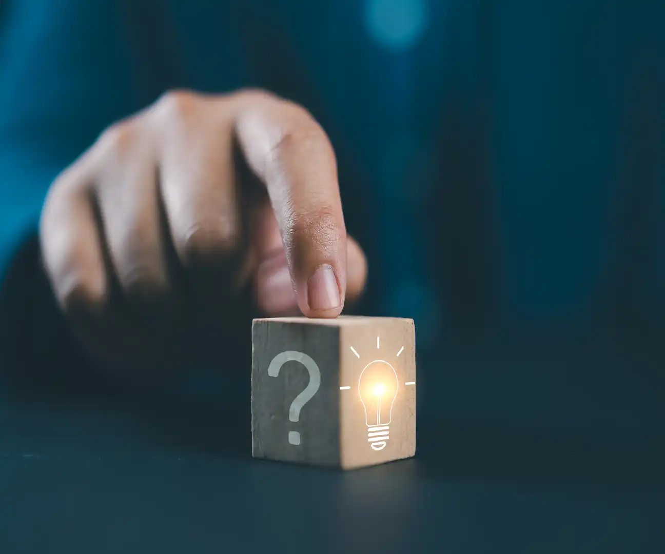 Hand points to a glowing cube with a question mark.
